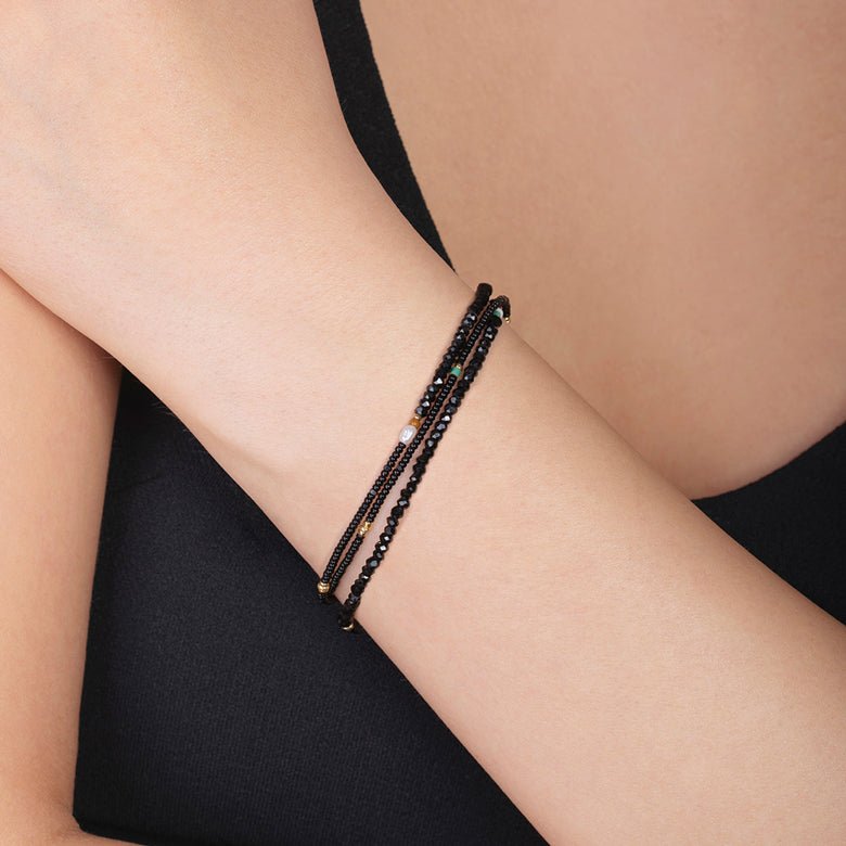 Pretty black beaded bracelet on the arm of woman.  Great gift from East Third Collective.