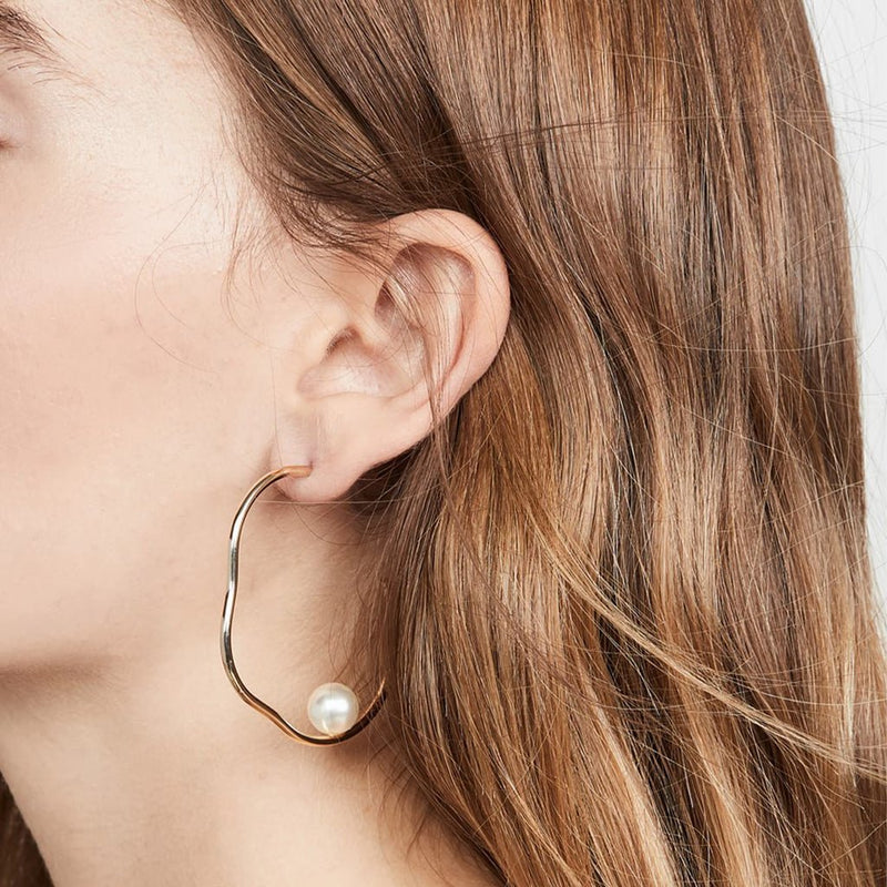 Close-up of beautiful earrings on model.