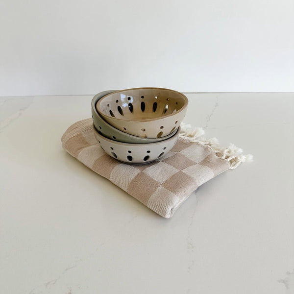 Three berry bowls in neutral colors on an oat checkered Turkish towel from state the label makes a great thank you gift.