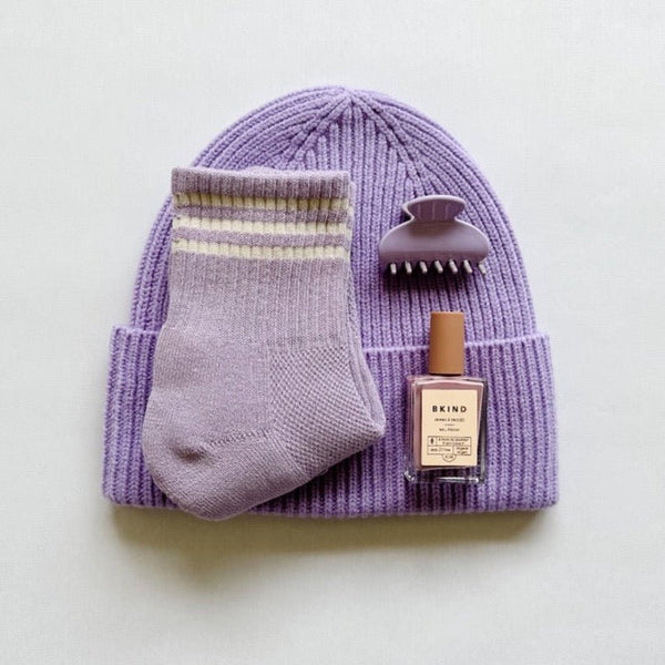 Tbco beanie in lilac paired with le bon shoppe socks, bkind nail polish and nat & noor hair claw for a perfectly purple gift.