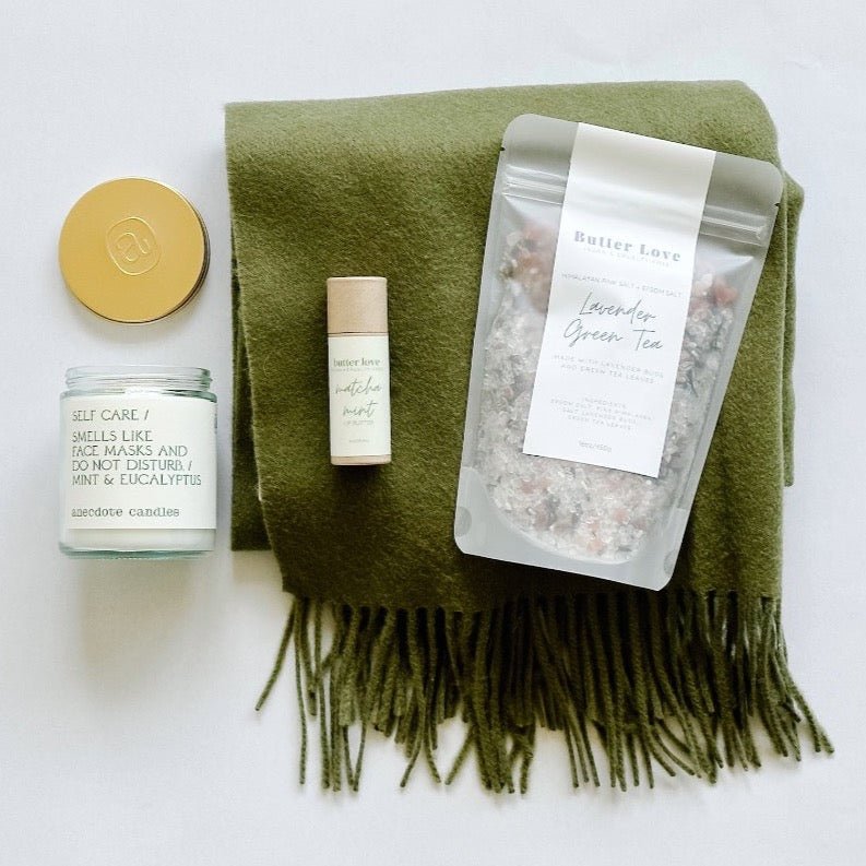 Warm them up this season with a tbco. scarf, lavender green tea bath soak, matcha mint lip balm and a self care candle from Anecdote.