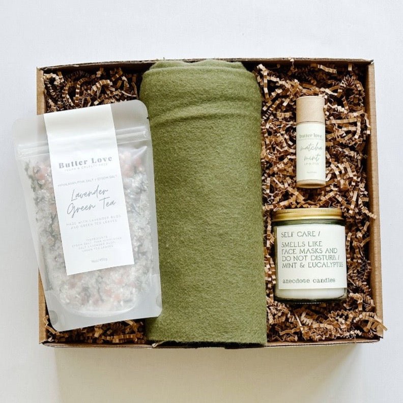 Warm them up this season with a tbco. scarf, lavender green tea bath soak, matcha mint lip balm and a self care candle from Anecdote.