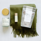 Warm them up this season with a tbco. scarf, lavender green tea bath soak, matcha mint lip balm and a self care candle from Anecdote.